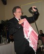 Rotarian Vic Bucher displays part of a Qutar headdress that he wore at a wedding for Qutar royalty